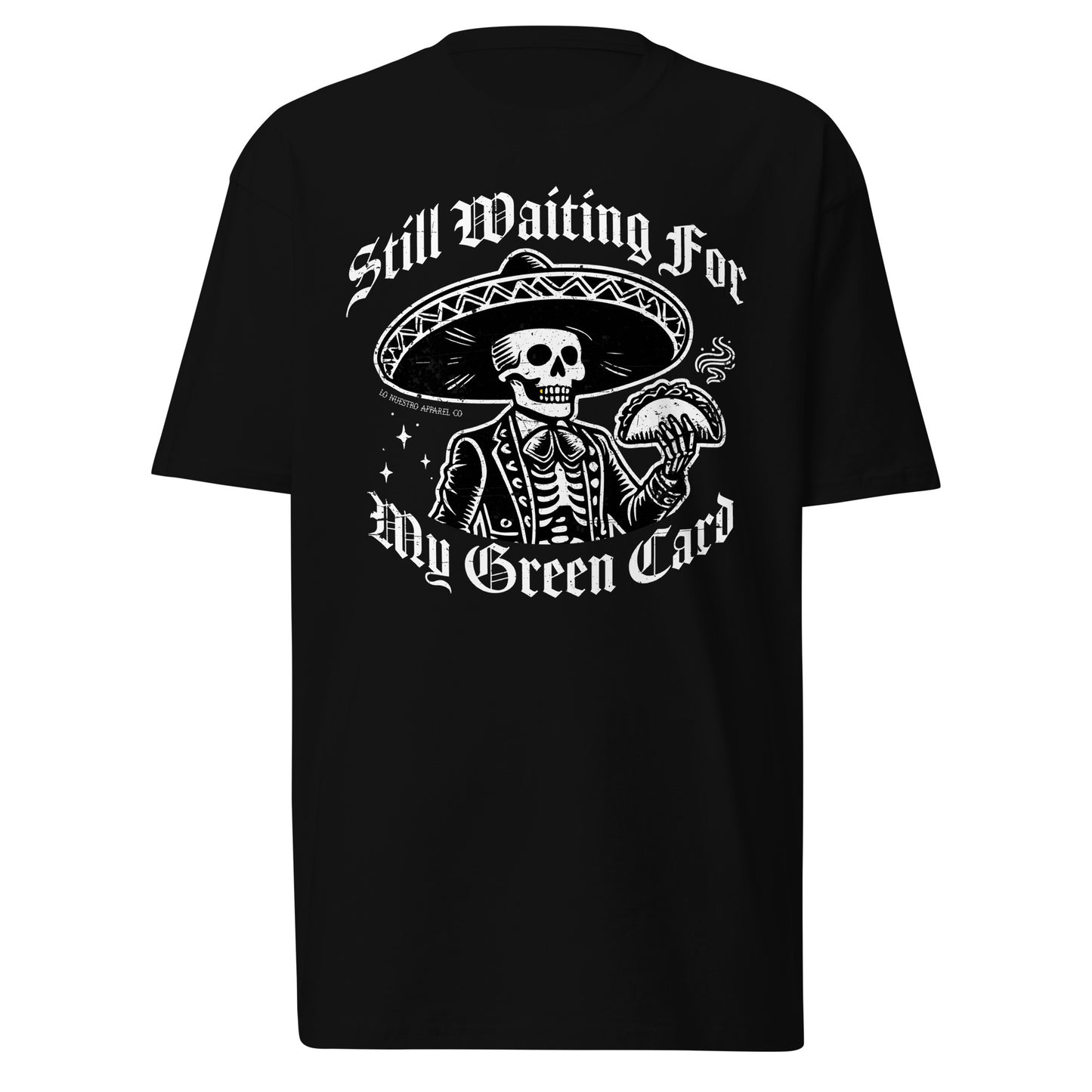 Funny Mexican shirt with a skeleton mariachi in a sombrero holding a taco, featuring gothic-style text that reads Still Waiting for My Green Card. This Chicano clothing design is displayed on a white background, perfect for those searching for funny shirts for men with cultural humor.