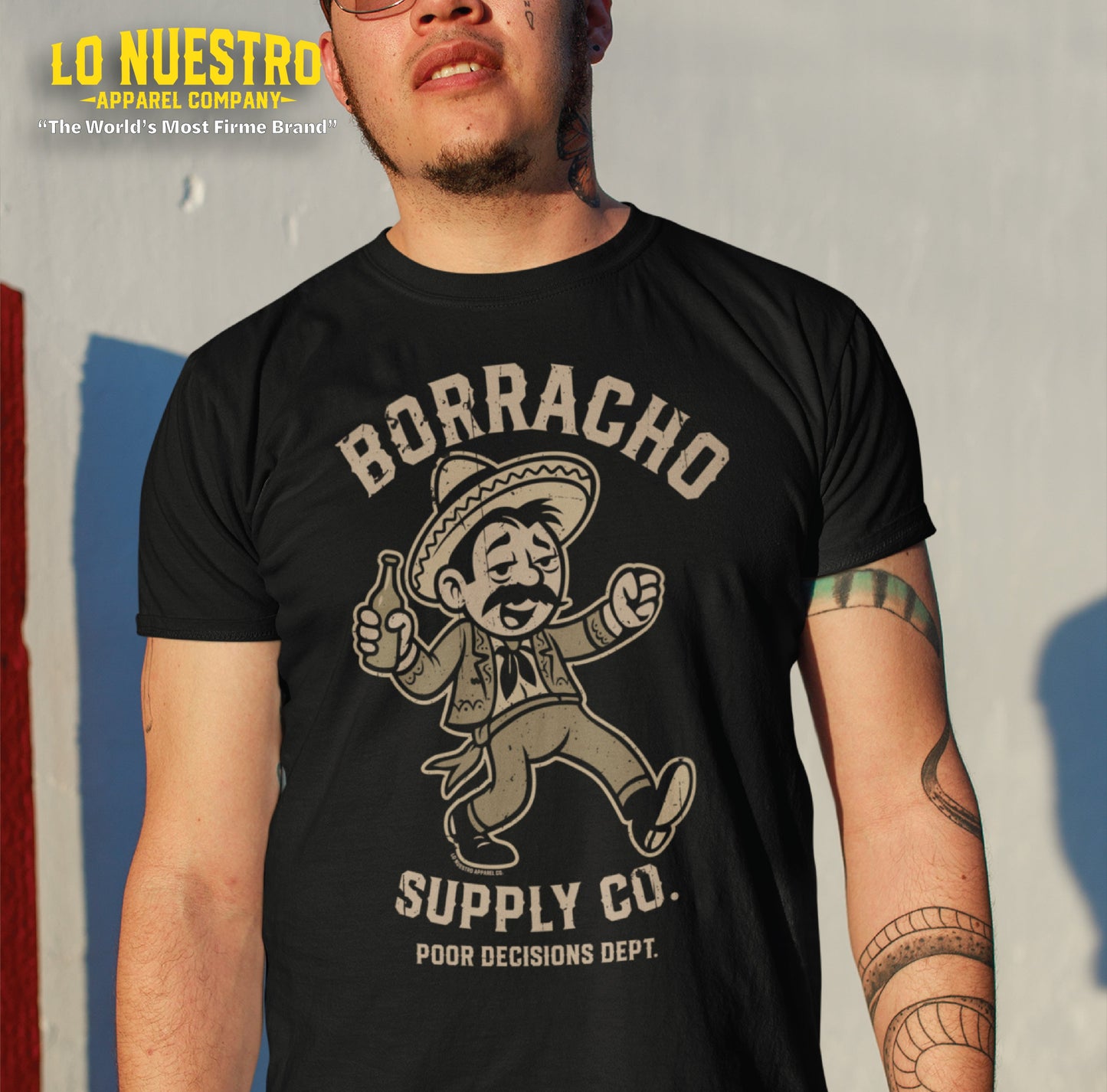 Tattooed man wearing a funny Mexican shirt featuring a drunk cartoon character. Perfect blend of Chicano clothing and street humor.