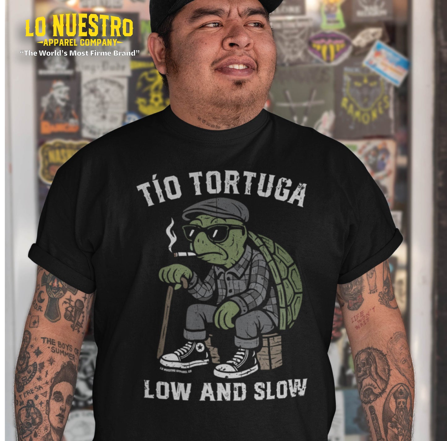 Model wearing a black Tio Tortuga t-shirt with cartoon turtle design, a funny Mexican shirt featured in Chicano clothing style.