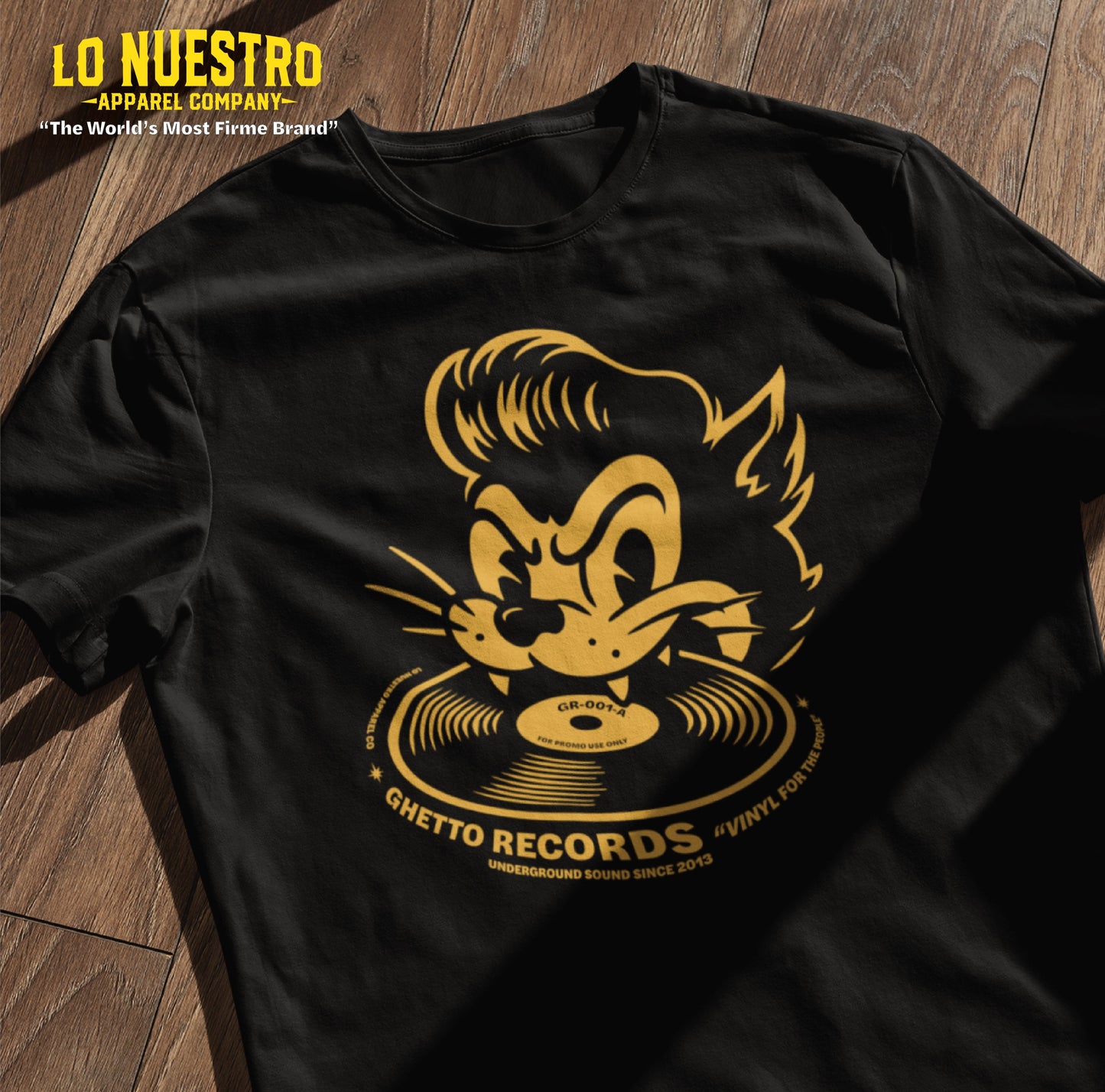 Chicano clothing flatlay t-shirt mockup on wooden surface showing Ghetto Records design with greaser cat, vinyl record, and Underground Sound Since 2013 print.