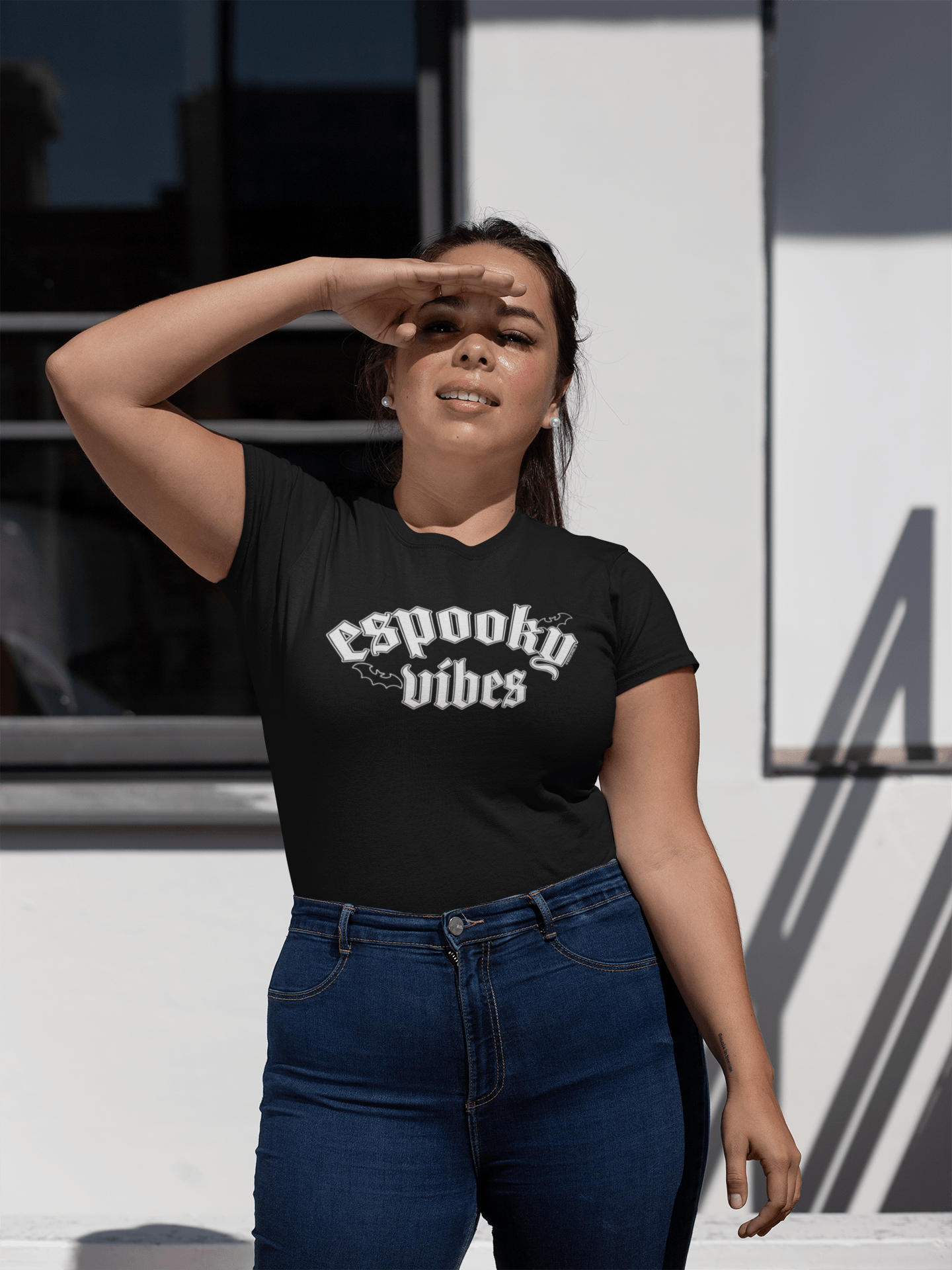 Woman wearing Espooky Vibes T-Shirt shielding eyes from the sun – Modern witchy style
