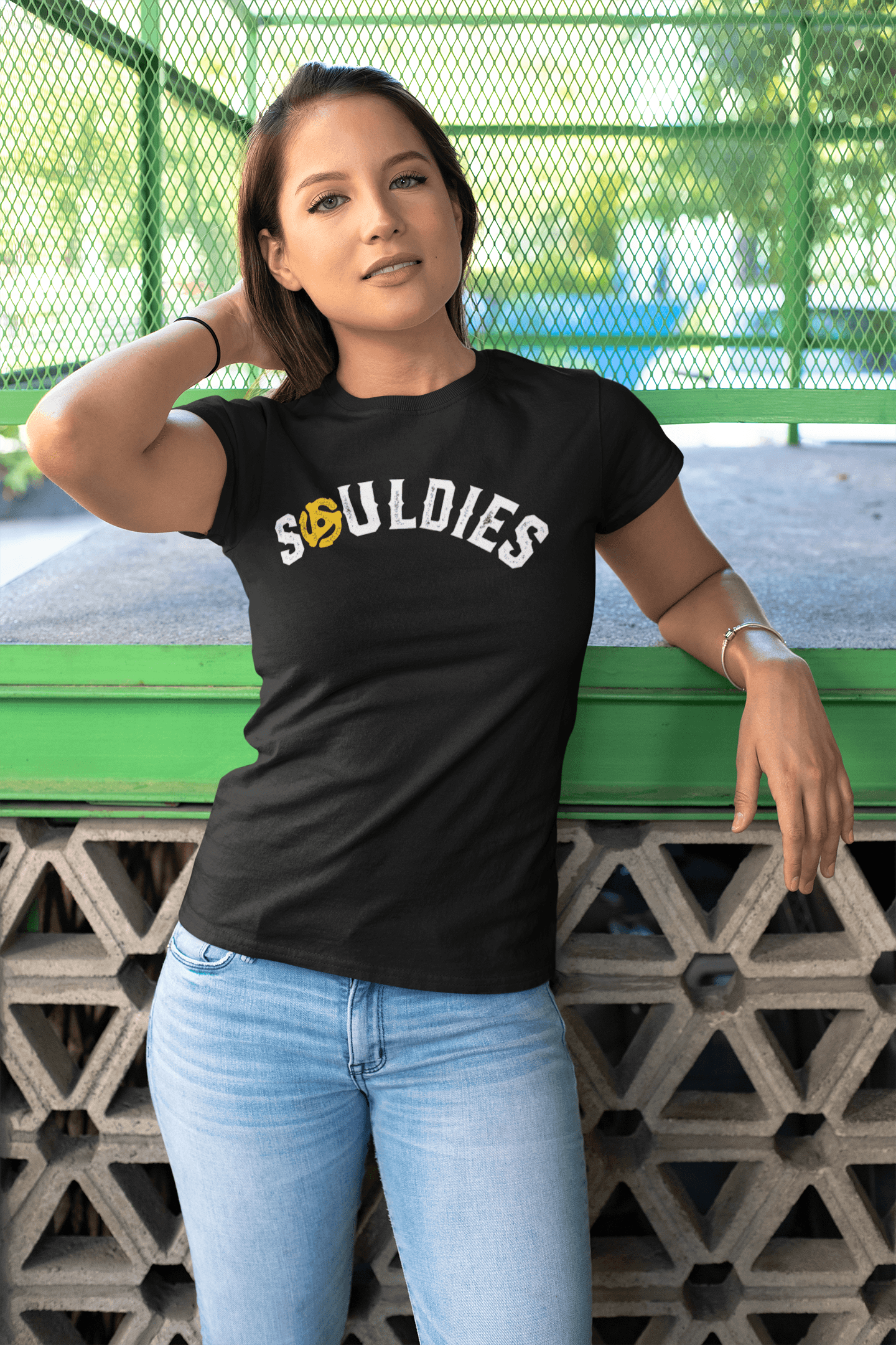 A young woman wearing a black t-shirt that says Souldies.