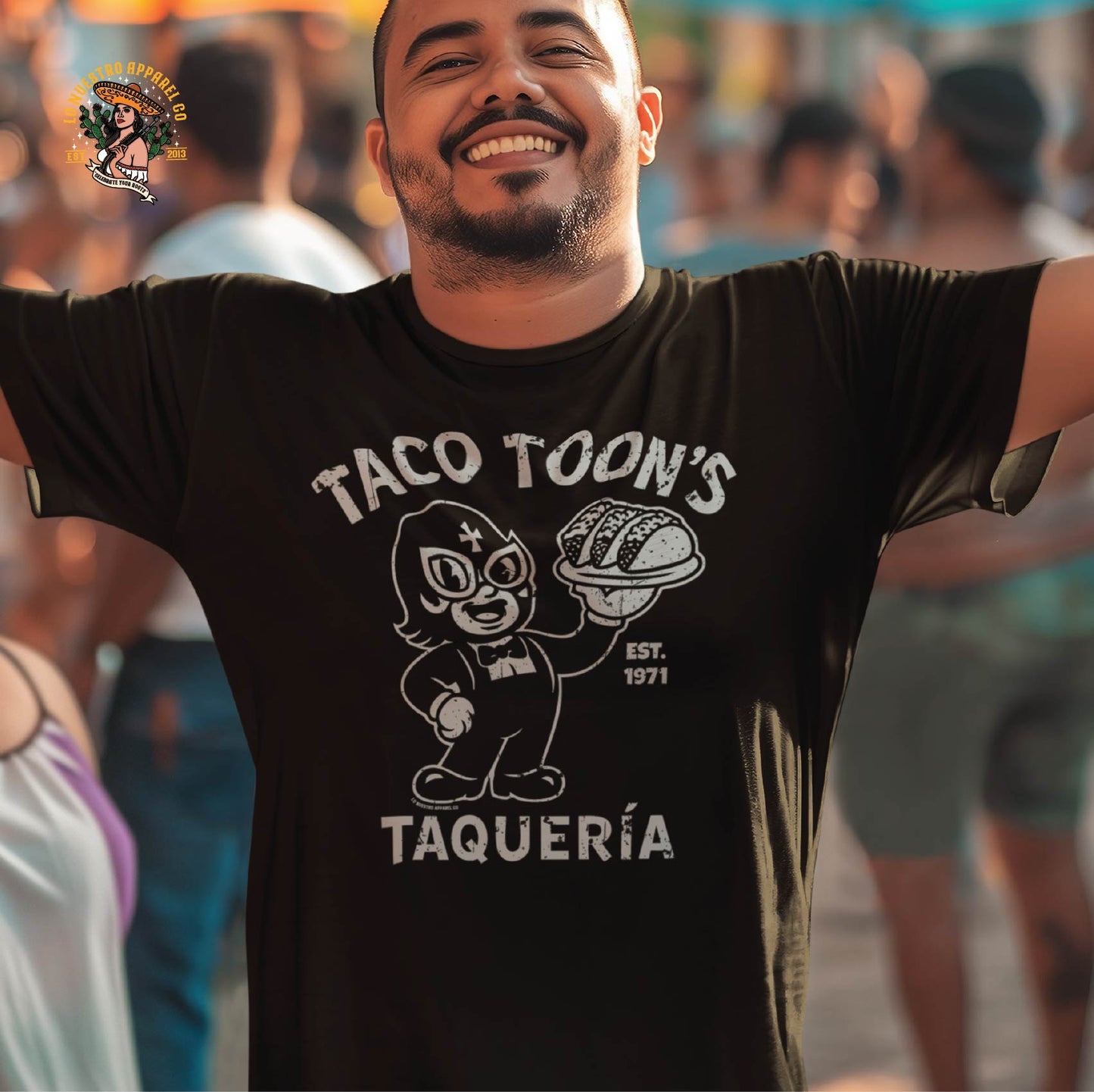Smiling man wearing the Taco Toon’s Taquería funny Mexican shirt at a street festival. A fun cartoon taco design for fans of funny shirts and cultura.