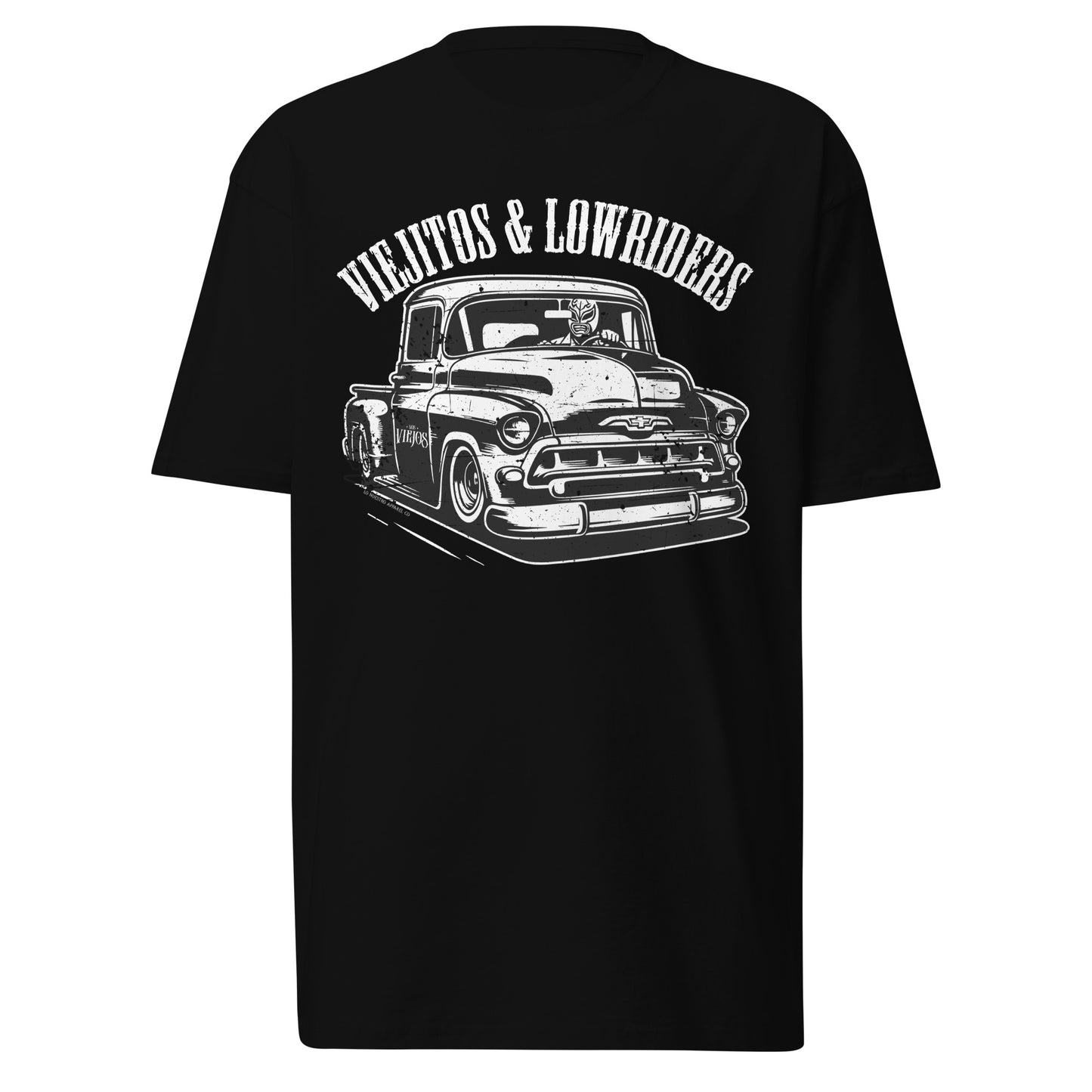The Viejitos & Lowriders lowrider t-shirt in black, featuring a vintage 1957 Chevy Stepside with a luchador driver. This Chicano clothing staple is perfect for men who love lowrider t-shirts and classic car culture.