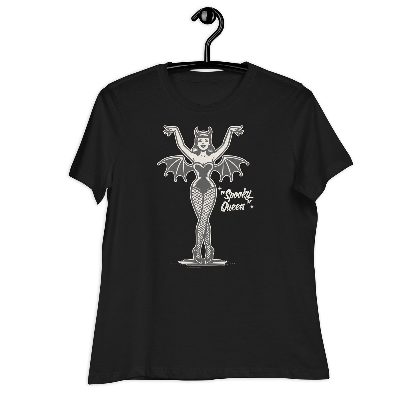 Women's black relaxed-fit 'Spooky Queen' Halloween t-shirt on a hanger featuring a retro pinup-style bat queen design with devil horns and wings, along with the text 'Spooky Queen' in vintage font.