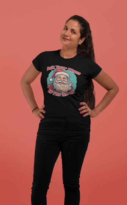 Woman posing in "Ask Your Mom If I'm Real" Unisex Funny Christmas T-Shirt against a pink background – Funny Christmas T-Shirt, Sarcastic Holiday Shirt, Santa Claus Tee.