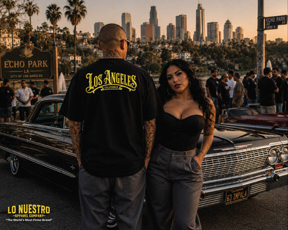 Back view of the Los Angeles Plaque t-shirt worn at Echo Park featuring the large plaque style Los Angeles back print with California lettering underneath beside a black 1963 Impala lowrider.