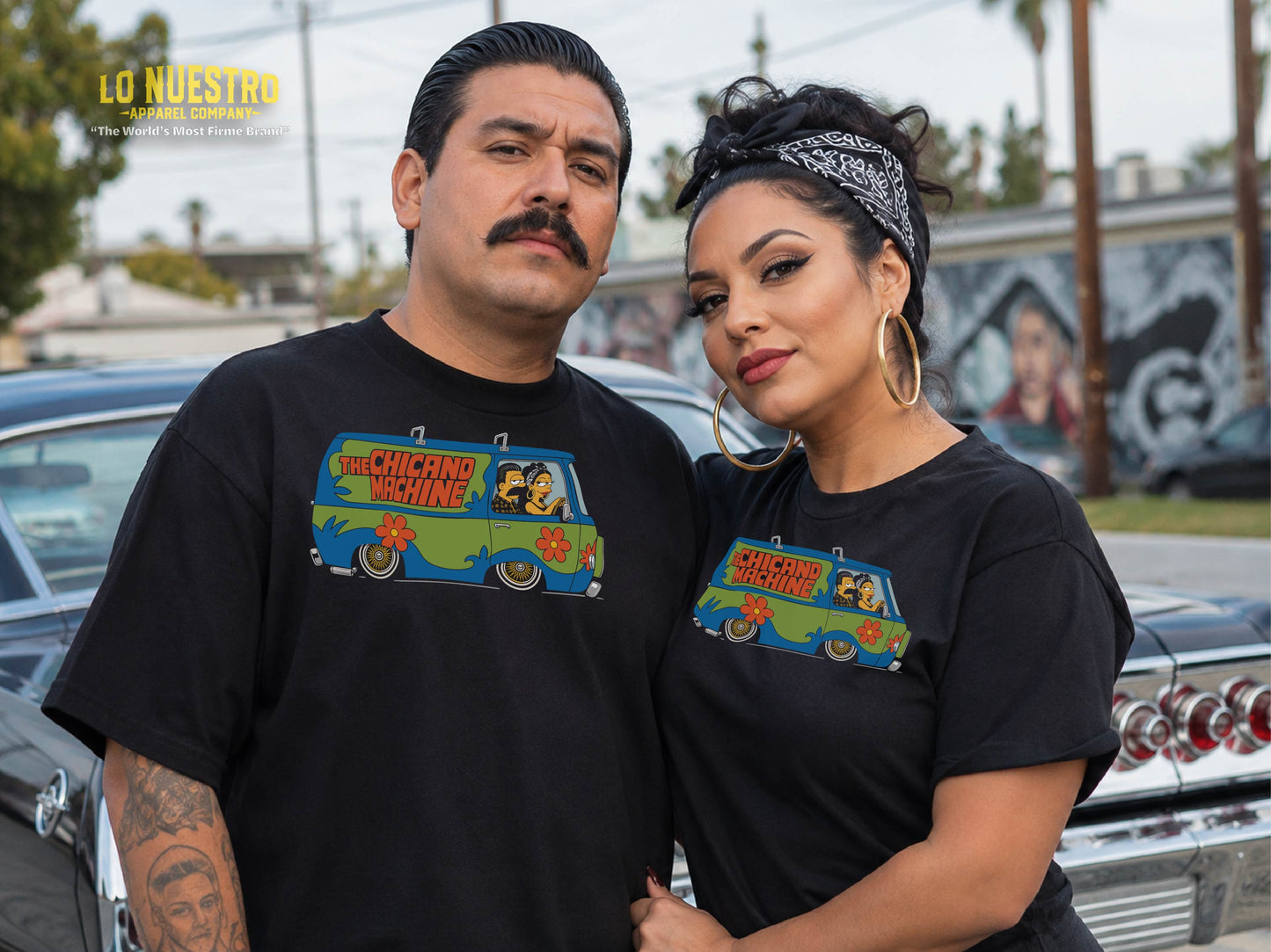 Photo of a Latino couple wearing black Chicano Machine T-shirts in a Southern California street setting.