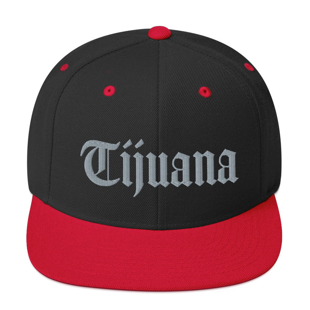 Black and Red snapback hat with "Tijuana" text in old English embroidery, adjustable fit, perfect for showcasing cultural pride.