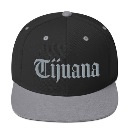 Black and Silver snapback hat with "Tijuana" text in old English embroidery, adjustable fit, adding a bold touch to urban streetwear.