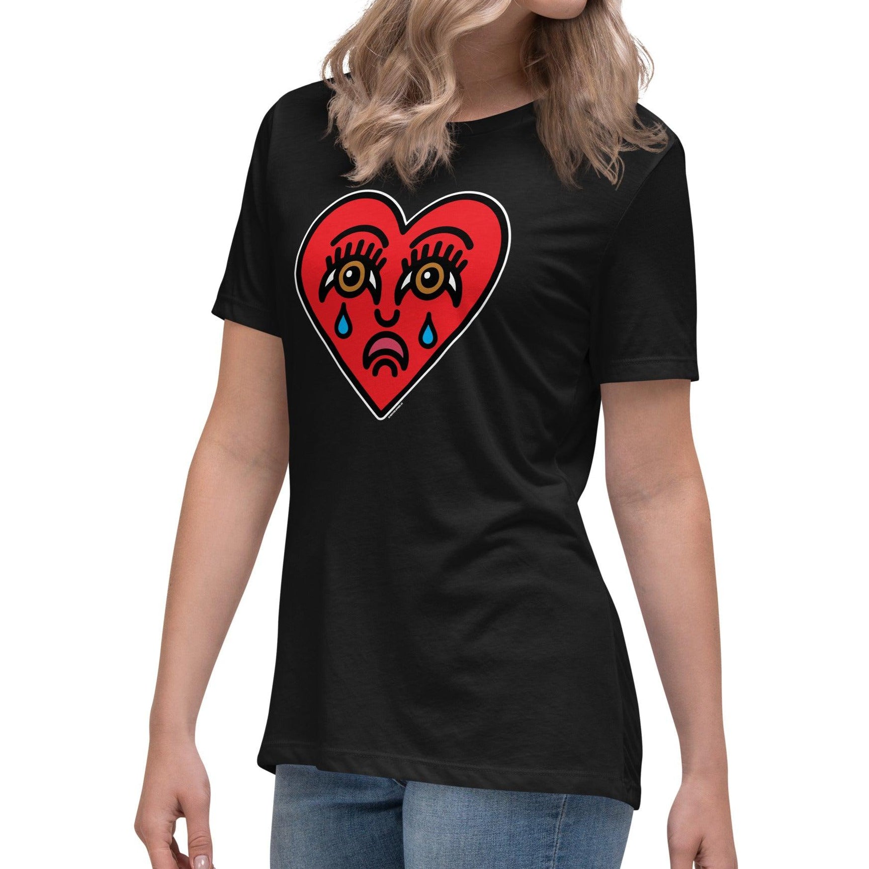 A woman wearing a black t-shirt with a vibrant crying heart tattoo design—perfect for Valentine’s Day or any bold statement look.