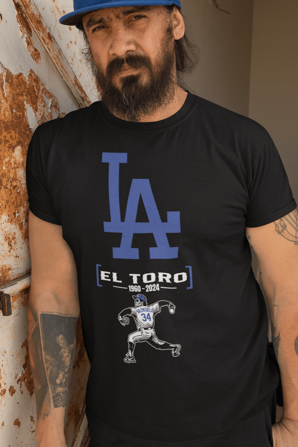 Man wearing an El Toro baseball tribute t-shirt featuring a pitcher graphic and bold blue LA lettering.