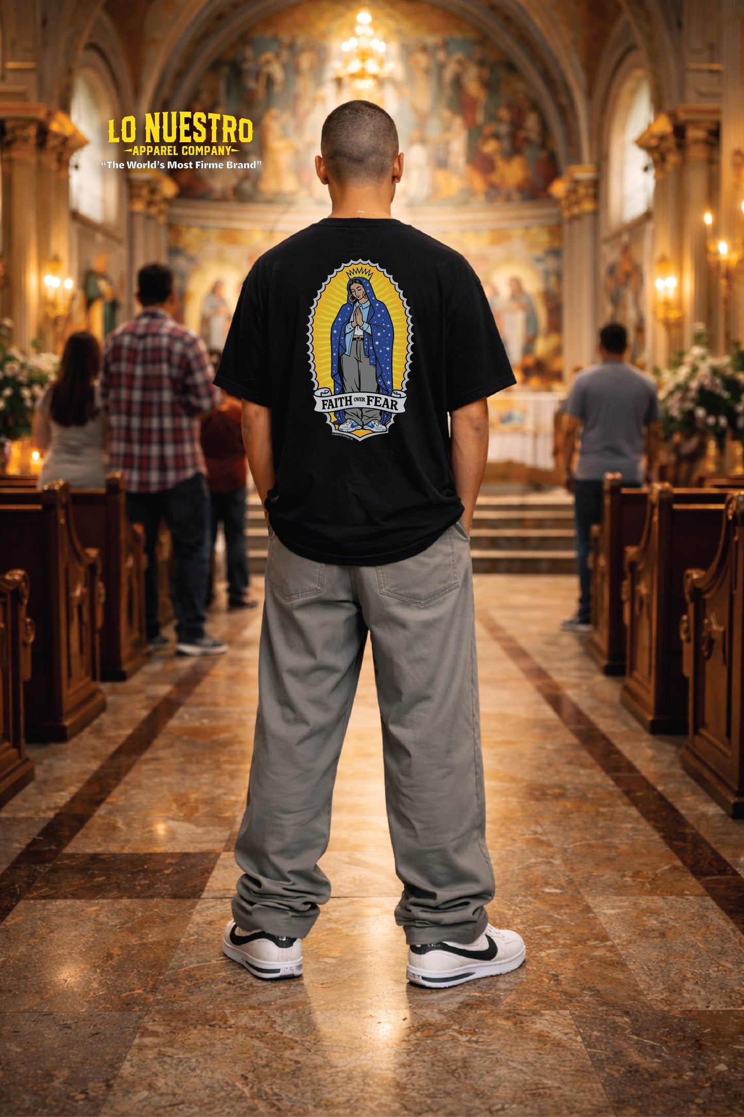 Man wearing Faith Over Fear t-shirt standing in a Catholic church facing the altar