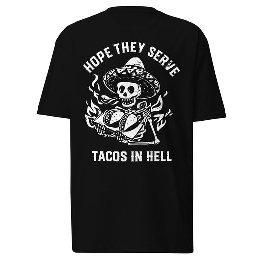 Hope They Serve Tacos in Hell t-shirt laid flat, showcasing a bold skull and tacos design with flames. This funny taco graphic tee is made of soft cotton and is a great choice for Mexican food fans and streetwear lovers.