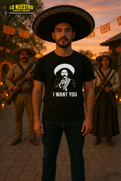 Model wearing a black t-shirt with a vintage I Want You graphic of a mustached revolutionary in a sombrero, set against a Día de los Muertos-style courtyard at sunset.