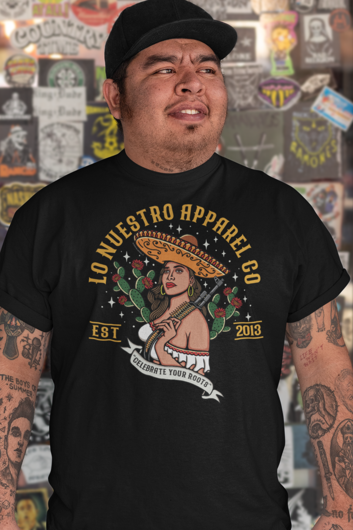 Model wearing La Charra Men's T-Shirt, a Chicano clothing piece inspired by Mexican heritage and cultura.