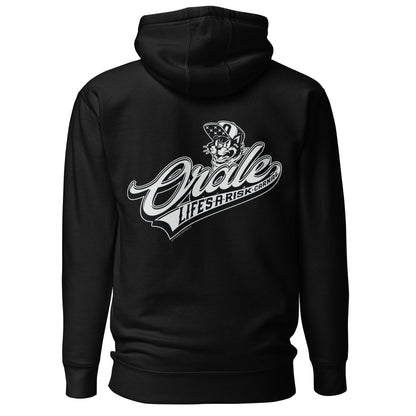 Back view of black hoodie featuring large "Órale Life’s a Risk Carnal" graphic with bold lettering and Chicano-inspired design.