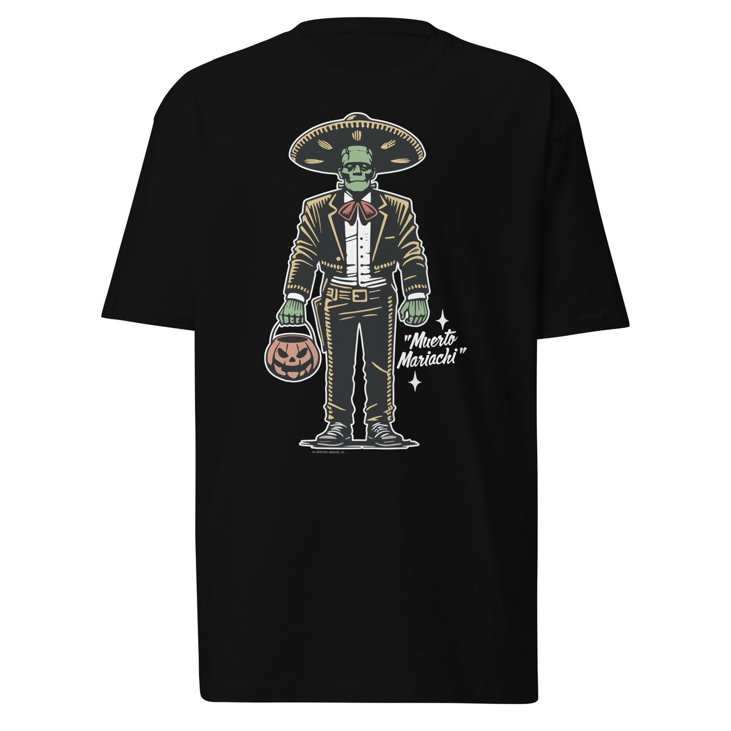 Black heavyweight t-shirt with a vintage Halloween design of a mariachi-themed zombie holding a jack-o-lantern bucket. The words 'Muerto Mariachi' are displayed beside the character.