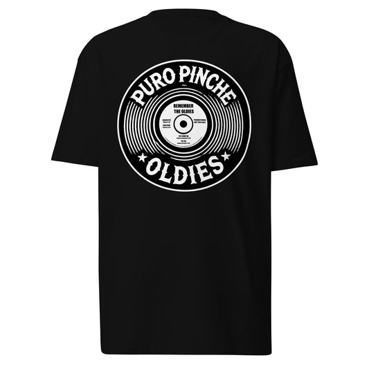 Front-facing view of a black graphic tee featuring bold 'Puro Pinche Oldies' text with a graphic of a vinyl record.