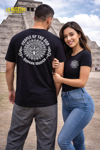 Couple wearing People of the Sun t-shirt at Aztec pyramid in Mexico featuring Sangre Mexica sun god design on black shirt