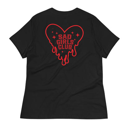 Black t-shirt laid flat featuring a red melting heart with stars and "Sad Girls Club" design, a vintage tattoo-inspired aesthetic.