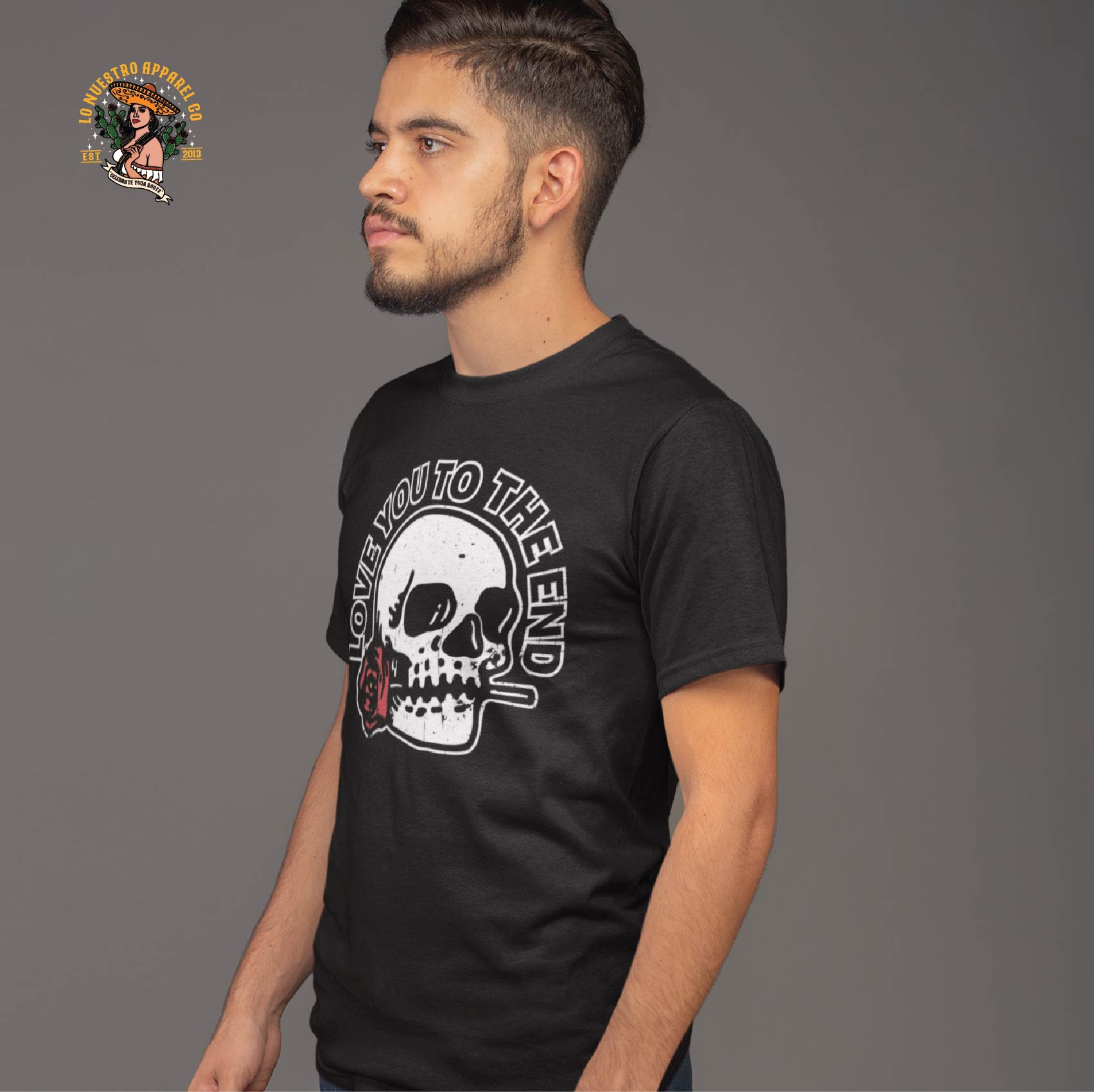 A side view of a male model wearing the Skull and Roses Shirt, featuring a distressed look. Part of our Chicano Clothing line.