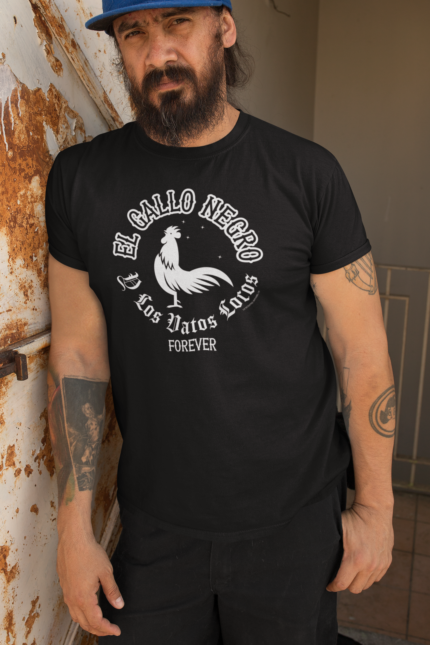 Model wearing the "El Gallo Negro Y Los Vatos Locos Forever" T-shirt to show the relaxed fit and comfortable style.