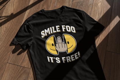 T-shirt mockup featuring the Smile Foo It's Free design on a wooden surface with window shadows.