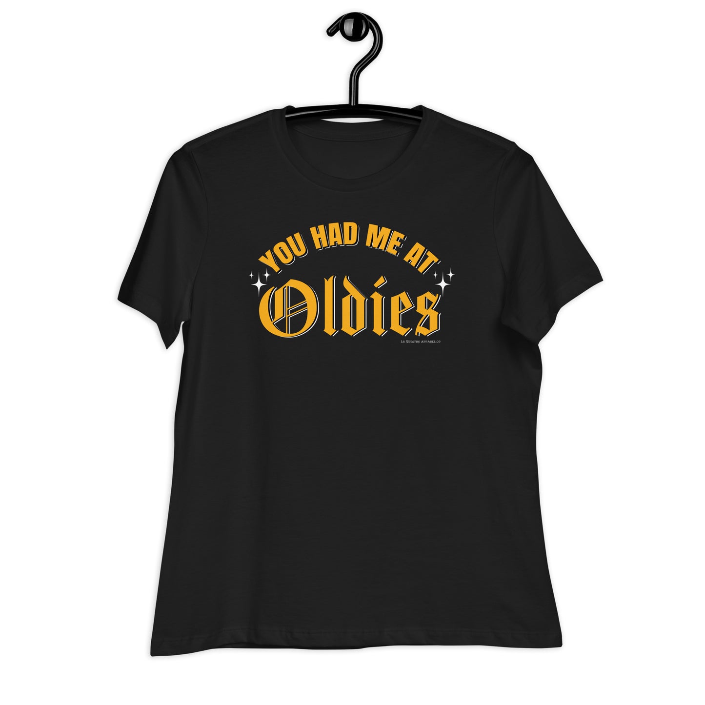 Close-up of the "You Had Me at Oldies" text on a black women's T-shirt, showcasing bold yellow old English lettering with sparkles.
