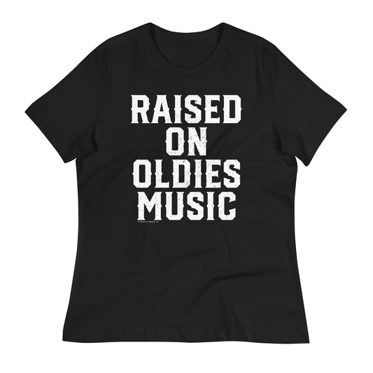 A black women's relaxed t-shirt with bold white text that reads 'Raised on Oldies Music.