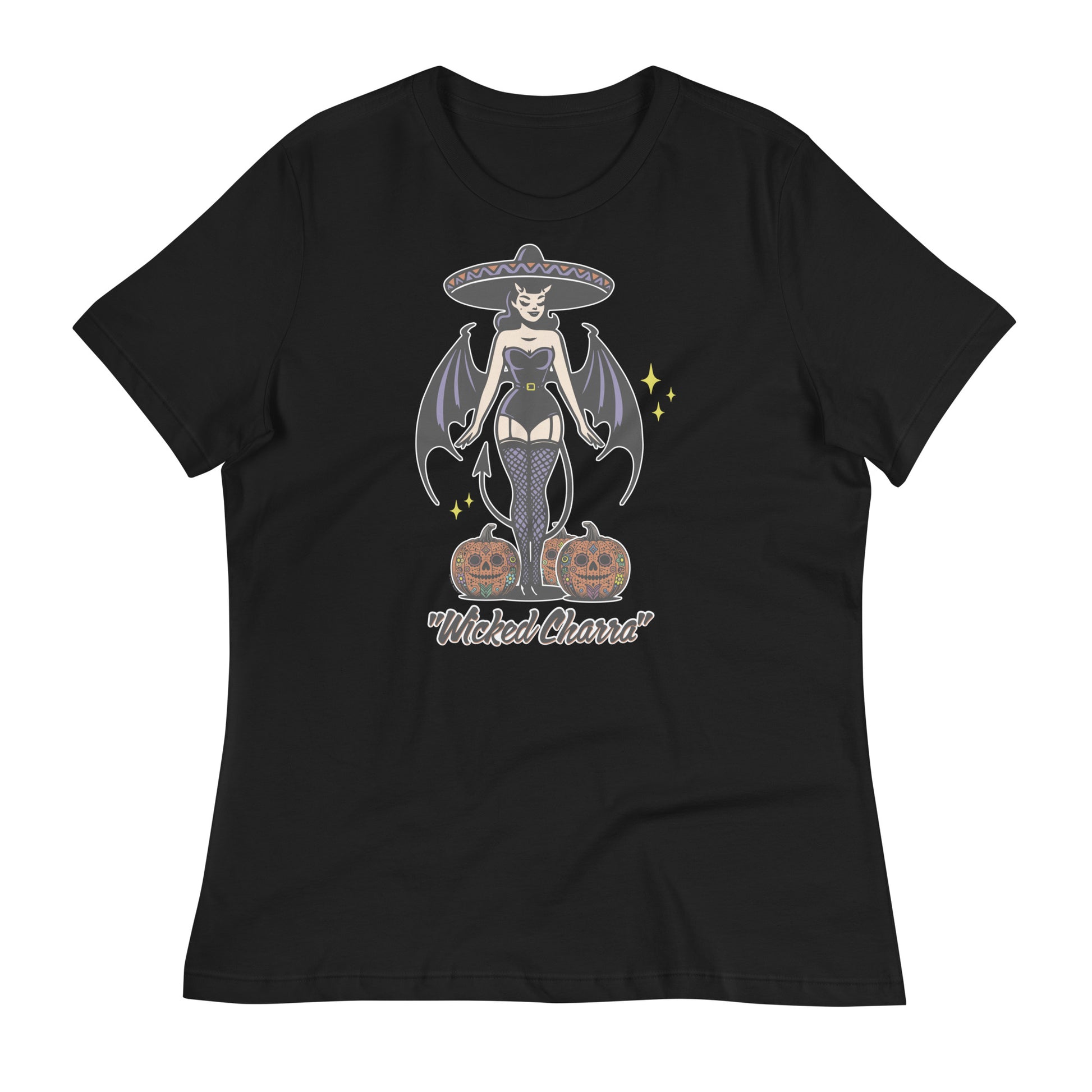 Women's relaxed-fit black t-shirt featuring a 'Wicked Charra' design. The illustration shows a retro-style charra with devil wings, a sombrero, and two jack-o-lanterns, blending Halloween and Día de los Muertos themes.