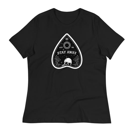 A close-up of a black t-shirt with a vibrant Planchette design featuring a skull at the base of the planchette and the evil eye at the top.