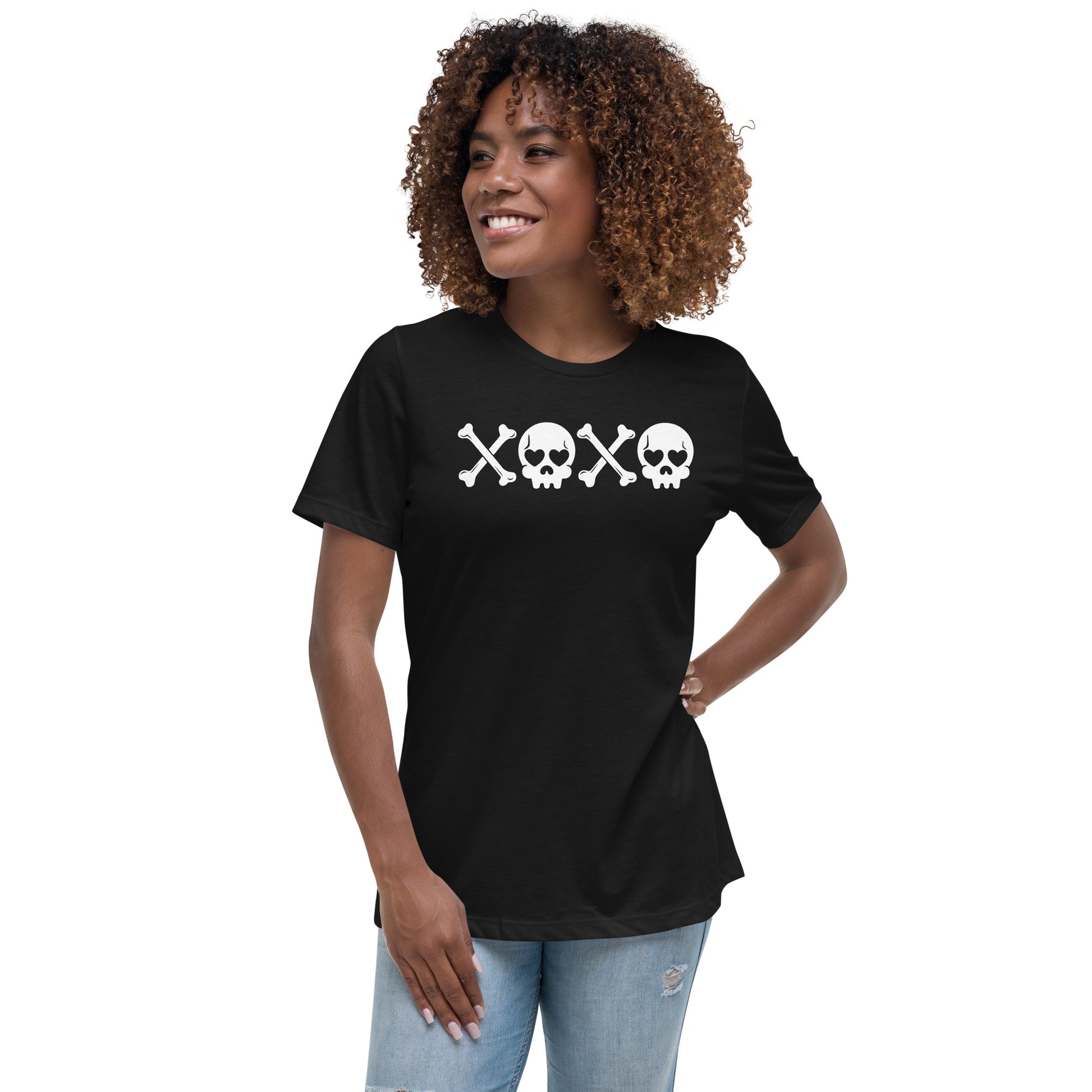 A young woman posing with a black tshirt with xoxo on the front.