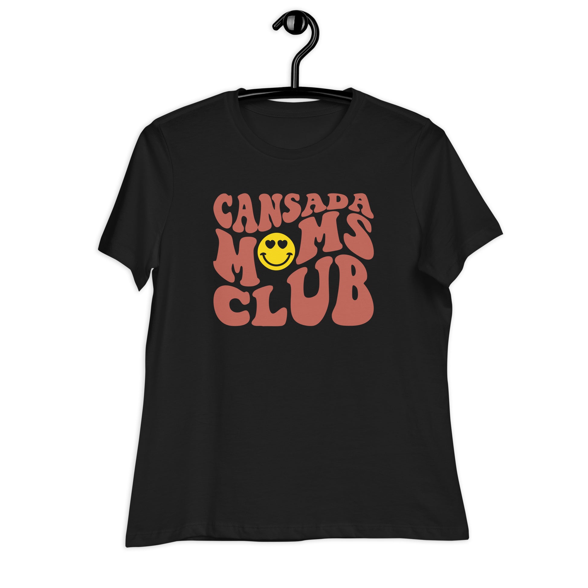 A black tshirt on a hanger with the words Cansada Moms Club with a happy face with hearts.