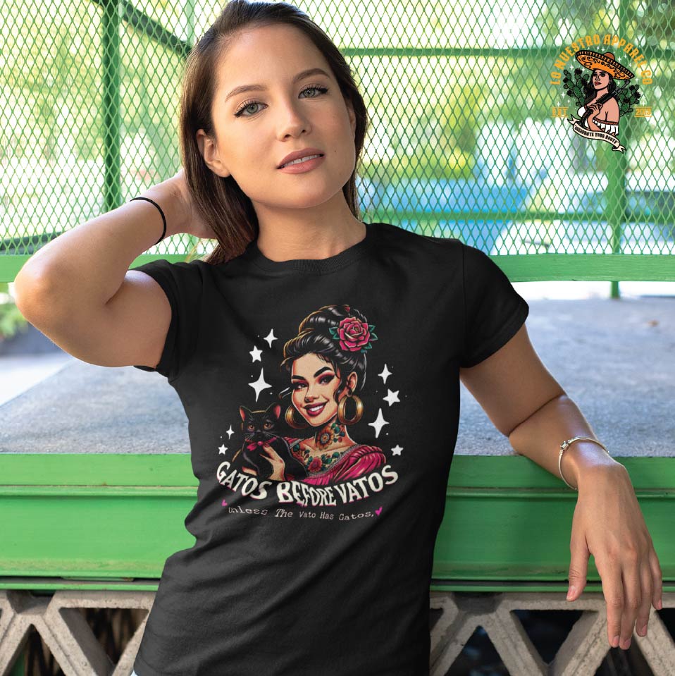 A young model wearing the Gatos Before Vatos Tattoo T-Shirt – Funny cat lovers tee with a playful phrase, perfect for those who put their felines first The best in chicano clothing and mexican clothing.